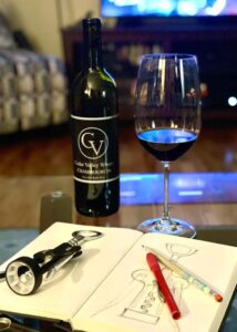 a bottle of wine and a wine glass on the table