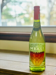 a bottle of wine on a table by the window